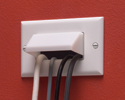 cable entrance plate mounted to wall with four wires run into it