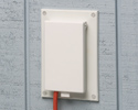 extension cord plugged into outdoor electrical box with cover closed