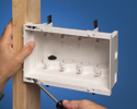 person mounting indoor in-box to wooden stud