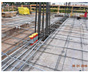 construction site ready for concrete pour, three conduit caps mounted on vertical conduit