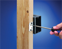 person changing depth of adjustable outlet box with screwdriver