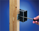 person changing depth of adjustable outlet box with screwdriver