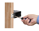person changing depth of adjustable outlet box with screwdriver