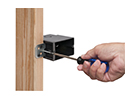 person changing depth of adjustable outlet box with screwdriver