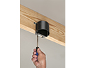 person mounting adjustable ceiling box to joist with screwdriver