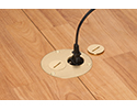 floor box in wooden floor with device plugged into receptacle