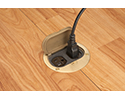 floor box in wooden floor with device plugged into receptacle