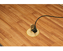 floor box in wooden floor with device plugged into receptacle