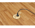 floor box in wooden floor with device plugged into receptacle