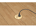 floor box in wooden floor with device plugged into receptacle