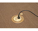 floor box in carpeted floor with device plugged into receptacle
