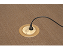 floor box in carpeted floor with device plugged into receptacle