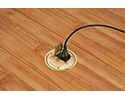 floor box in wooden floor with device plugged into receptacle