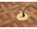 floor box in wooden floor with device plugged in