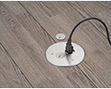 floor box in wooden floor with device plugged in