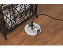 floor box in wooden floor with device plugged in