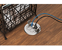 floor box in wooden floor with devices plugged in