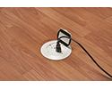 floor box in wooden floor with device plugged in