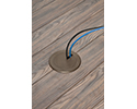 floor box in wooden floor with two devices plugged in