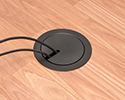floor box in wooden floor with devices plugged in