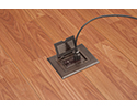 floor box in wooden floor with device plugged in