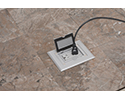floor box in tiled floor with device plugged in