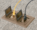 Two gang floorbox installed in carpeted floor with device and ethernet plugged in