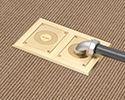 two gang floor box in carpeted floor with 90 degree connector and conduit attached