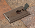 single gang floor box in tiled floor with flip lid open