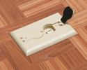 single gang floor box in wooden floor with flip lid open