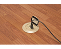 floor box in wooden floor with device plugged in