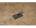 floor box with flip lid open in tiled floor