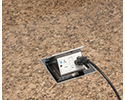 pop up countertop box in granite countertop with device plugged in