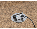 pop up countertop box in granite countertop with device plugged in