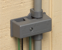 intersystem grounding bridge with PVC adapter installed to siding