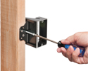 person adjusting depth of mounting bracket on wooden stud with screwdriver