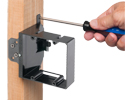 person securing support tab to wooden stud with screwdriver