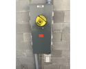 multiple meter mounting bases mounted on concrete block wall with large meter installed