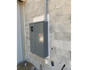 multiple meter mounting bases mounted on concrete block wall with large meter installed