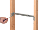 person mounting slider bar between two wooden studs