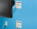 bridge kit in wall, upper box hidden by TV, lower box plugged in to outlet