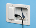 TV box in wall with device plugged in