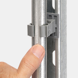 QuickLATCH mounted to beam while a metal conduit is being installed